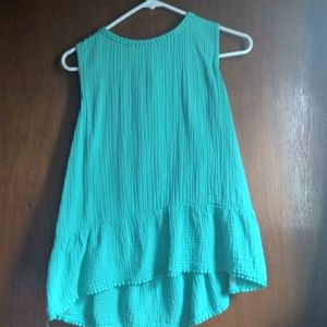 A backless turquoise sleeveless shirt